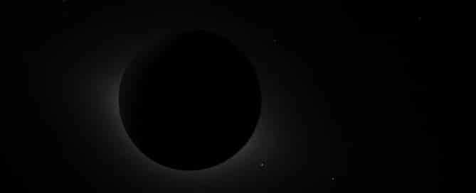 Total solar eclipse: the Moon blocks the Sun, with a faint solar corona around the edge.